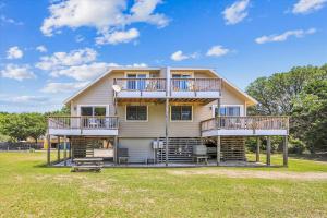 a large house with balconies and a yard at Emerald Duck in Duck