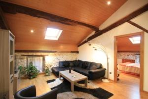 a living room with a couch and a bed at Etxezuria in Valcarlos