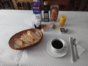 a basket of bread and a cup of coffee on a table at Posada San Miguel in RIonansa