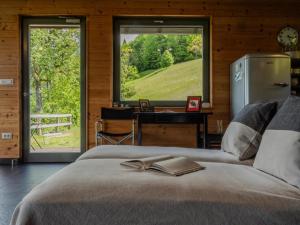 a bedroom with a bed with a book on it at St Barbara Hideaway in Škofja Loka