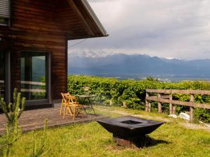 a wooden deck with a table and a chair on a house at St Barbara Hideaway in Škofja Loka