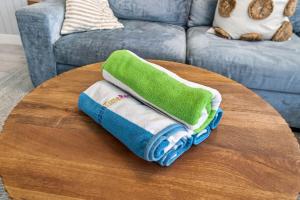 a pile of towels on a table in a living room at Island Vibes House in Clearwater Beach