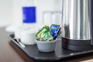 a counter with a container of chips and a food processor at Hotel Livora in Alwaye