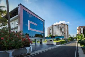 a building with the letter e on the side of a street at Hotel Livora in Alwaye