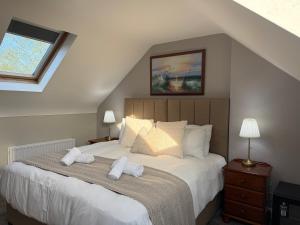 a bedroom with a bed with two towels on it at All Seasons Guesthouse in Belfast