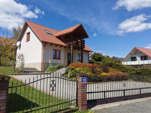 a house with a wrought iron fence at Noclegi u Gosi w Polańczyku in Polańczyk