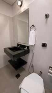 a bathroom with a black sink and a mirror at ADD Hóteis Congonhas in São Paulo