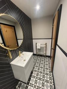 a bathroom with a sink and a mirror at Strathmore Guest house in Fort William