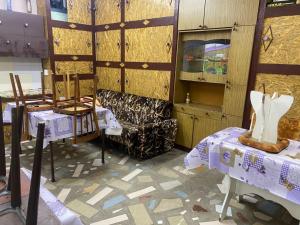 a room with two tables and a chair and a cabinet at уют in Cholpon-Ata