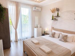 a bedroom with a large bed with two towels on it at Aloft House in Kutaisi