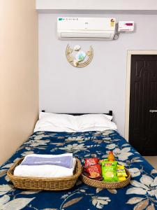 a bedroom with a bed with baskets of toys on it at Triveni Stays in Jorhat