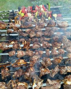 a grill with meat and other foods on it at Leila's Guest House in Joqolo
