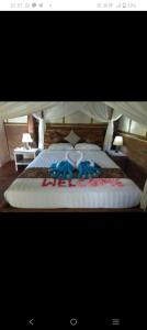 a bedroom with a large bed with two pillows at jungle house in Jatiluwih