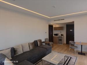 a living room with a couch and a table at Limeridge Signature Hotel in Ikeja