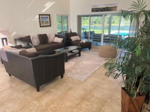 a living room with a couch and a table at SWISS 24 - Lake Stephanie in Clermont +9 photos