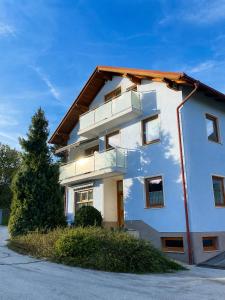 a white building with balconies on the side of it at Apartma Arbores in Sveti Jurij ob Ščavnici
