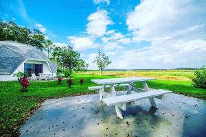 a picnic table in front of a field at ROOM 03 - Lake Sumner in Clermont