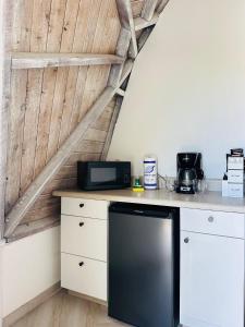 a kitchen with a black refrigerator on a counter at ROOM 04 - Lake Sumner in Clermont