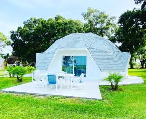 a round tent with a table and chairs in a field at ROOM 04 - Lake Sumner in Clermont