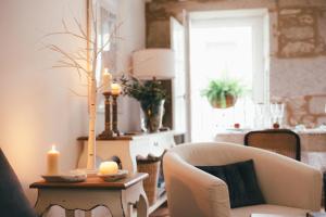 - un salon avec une chaise et une table avec des bougies dans l'établissement Apartamentos Aurelia Antica, à Saint-Jacques-de-Compostelle