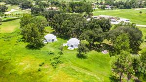 an overhead view of two tents in a field with trees at STUDIO 05 - Lake Sumner in Clermont