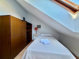 a bedroom with a bed and a wooden cabinet at La Cometa de Ajo -12016 in Ajo