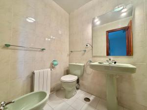a bathroom with a sink toilet and a mirror at La Cometa de Ajo -12016 in Ajo +11 photos