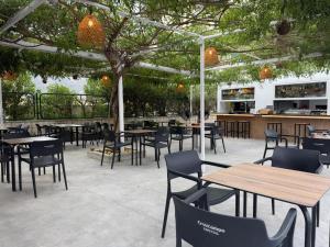 a restaurant with tables and chairs under a canopy at La Posada Boutique rooms Albir in Albir