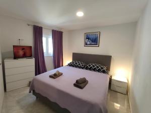 a bedroom with a bed with two brown pillows on it at Villa TOP HILL - Private Pool & Jacuzzi in Makarska +35 photos