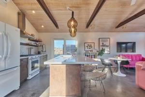 a kitchen with a large island and a pink couch at The Giddyup in Pioneertown +35 photos