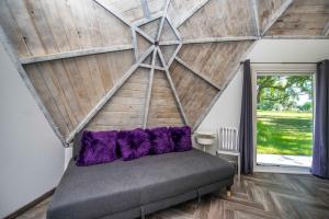a bed in a room with a wooden ceiling at STUDIO 02 - Lake Sumner in Clermont