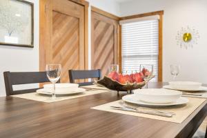 a dining room table with plates and wine glasses at Bird's Nest -2BR Downtown Saugatuck Walkable in Saugatuck
