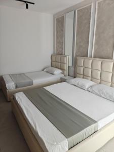 two beds in a room with at SeaView Vacation Rooms in Durrës