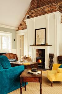 a living room with a blue couch and a fireplace at Number 6 Narrow Water Castle in Warrenpoint