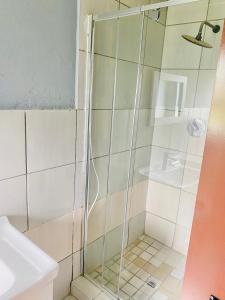 a shower with a glass door in a bathroom at Mabutane Villas in Badplaas +8 photos