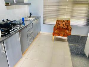 a kitchen with a chair in the middle of it at Mabutane Villas in Badplaas