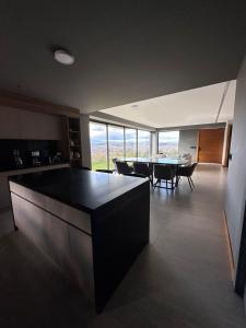 a large kitchen and dining room with a table and chairs at Casa con vista a cuenca in Cuenca