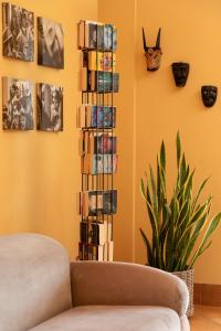 a living room with a couch and a stack of books at Marin Hotel in Pula