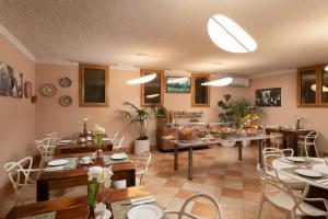 a dining room with tables and chairs in a room at Marin Hotel in Pula