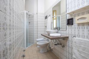 a bathroom with a toilet and a sink and a shower at Hotel Welt in Gatteo a Mare