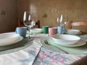 a table with plates and wine glasses on it at BOA VISTA in Combarro