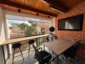 a room with a table and a large window at Sori Apartments in Lima