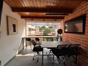 a room with a table and chairs on a balcony at Sori Apartments in Lima