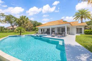 a swimming pool in front of a house at SWISS 101 - Lake Olsen in Clermont