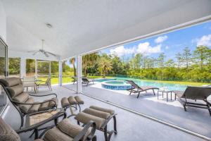 an image of a living room with a pool at SWISS 101 - Lake Olsen in Clermont
