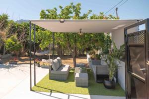 a pergola with couches and chairs on a patio at Casa Miniera in Linopótis