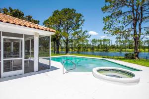 an image of a swimming pool with a house at SWISS 23 - Lake Stephanie in Clermont