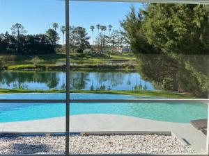 a view from a window of a swimming pool at SWISS 28 - Lake Stephanie in Clermont