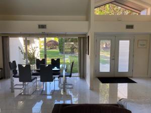 a dining room with a table and chairs and sliding glass doors at SWISS 28 - Lake Stephanie in Clermont +39 photos
