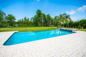 an empty swimming pool in a yard with trees at SWISS 105 - Lake Olsen in Clermont